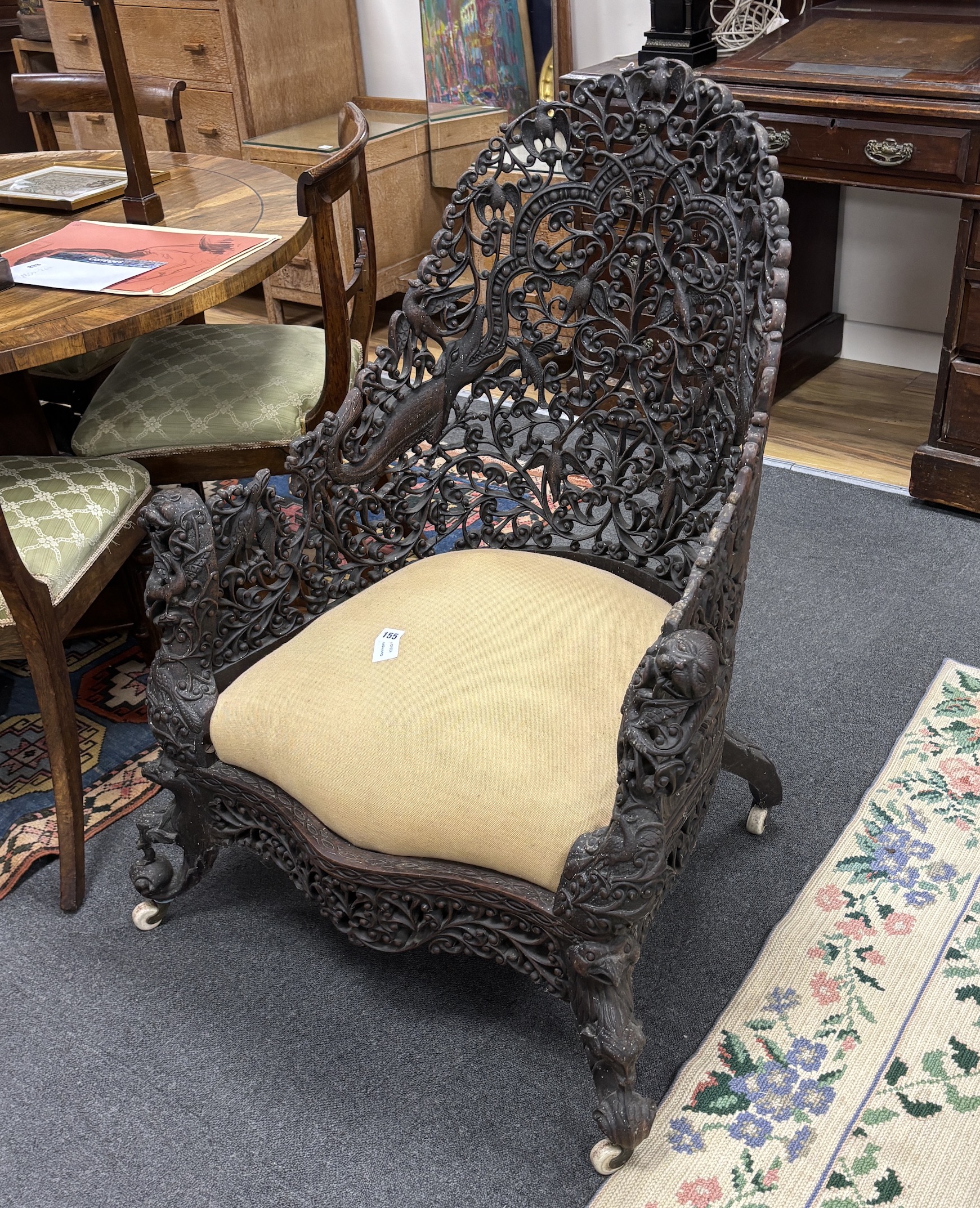 An Anglo Indian carved hardwood armchair, width 75cm, depth 58cm, height 100cm